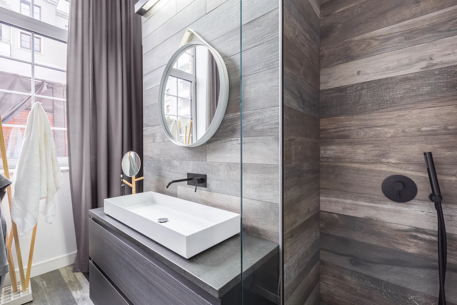 Bathroom with walk in shower and white countertop basin